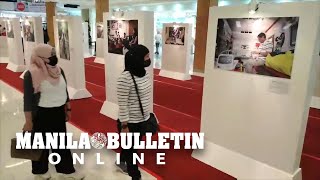 Mall goers take a glimpse of the photo exhibition featuring former Pres. Duterte in  Davao City