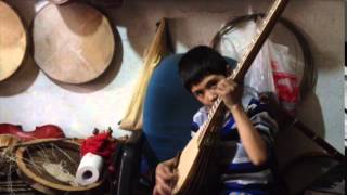 Uyghur child playing the tambur