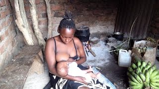 African village mom cooking delicious meal while doing educational breastfeeding