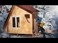 A wooden house in the middle of the forest. Construction in winter