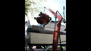 Hoist to remove inboard boat engine, using standard automotive hoist.