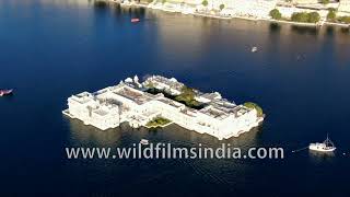 City Palace daytime aerial view, with Jal Mahal, Taj Lake Palace shimmers in winter sun, in Udaipur