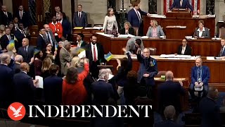 Representatives celebrate and wave flags after US Congress passes Ukraine aid pa