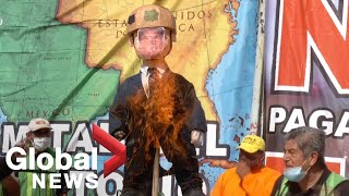 Migrant activists burn Trump effigy at US-Mexico border, call for voters to reject re-election