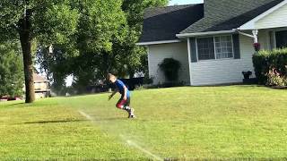 Logan getting ball while trying to beat the sprinkler 7/31/17