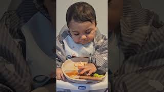 Self-feeding: 50% in the mouth, 50% on the floor, 100% adorable! 😍🥑 #TinyFoodie #ParentingJoys