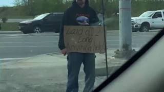 Man with cardboard sign gets gift from stranger