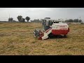 fm world rice combine harvester in field