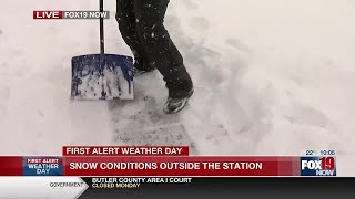 Shoveling snow amid the heavy snow falling in Queensgate