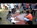 Download Dogs and humans relax together, on ground mats, prior to dog races in India In Mp4 3Gp Full HD Video