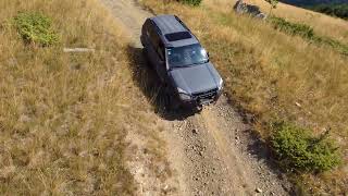 Drive up to Mt Korab peak, drone tracking through woods.