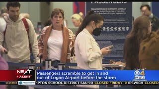 Airline passengers scramble to get in and out of Logan Airport before storm