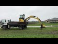 unloading a digger off a truck with out ramps.