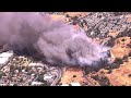 Raw Video: Vegetation fire burns near buildings in Martinez