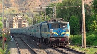 Full Blue Train - Pune Indore Express behind CNB WAG-7 Locomotive accelerating at Neral, India