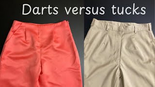 What is the difference between using a dart or a tuck on a garment?