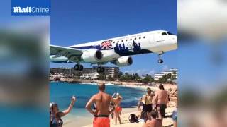 Tourist captures footage of plane passing just overhead of people on Maho Beach