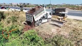 Perfect Small Komatsu Bulldozer Pushing Dirt With Dump Trucks Dumping Dirt Fill In The Soil Edge