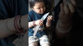 Small girl cutting Betel nut