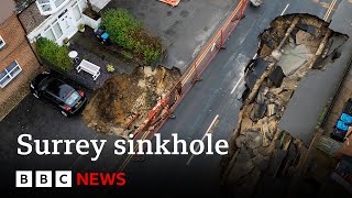 Huge sinkhole in Surrey swallows up more of street | BBC News