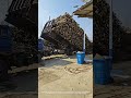 unloading wood from dump truck