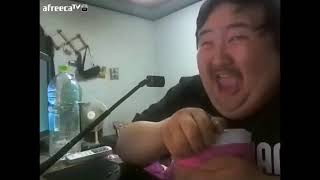 Fat Asian guy laughing at his ice cream