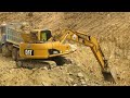 excavator use Caterpillar long hand cut stone canal loading land Trucks Delivery pouring out