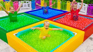 Vlad y Niki juegan al Desafío de globos de agua de cuatro colores para niños
