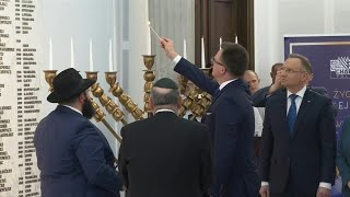 Poland's Duda takes part in ceremony relighting Hannukah candles doused by far-right lawmaker | AFP