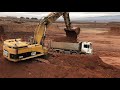 caterpillar 365c excavator loading trucks