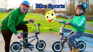 Jason and Alex play bike sports in park