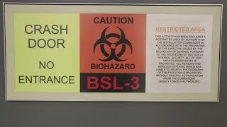 USAMRIID Biosafety Level 3 Door Sign & Scientists at work