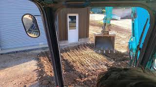 Digging out a base for a concrete pad with a Kobelco 8 ton dexcavator