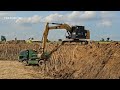 excavator cat 320c and land truck is working. excavator. land truck.