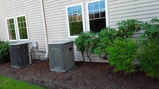 Two Lennox central air conditioners. (One running)