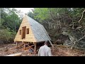 a frame cabin build installing the roof standing seam metal roofing