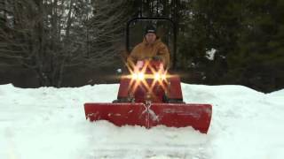 Steiner 440 Tractor with V-Blade Attachment