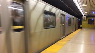 A northbound subway is leaving Dundas subway station and another subway northbound subway arrives