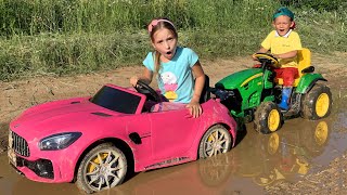 Sofia stuck in the mud Max ride on Power Wheels Tractor to help