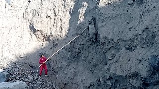 DROPPING SOLID CHUNKS OF SAND USING LONG BAMBOO