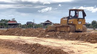 Bulldozers CAT D3K LGP pushing land for road projects with Roller SAKAI,KOBELCO,5T Dump truck