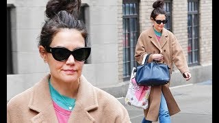 Katie Holmes goes for a layered look with a coat over two T-shirts... after posing in her lingerie f