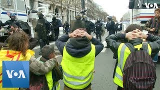 Protesters Kneel Before Police in Shopping District at Paris Protest