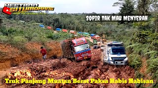 Heavy Loaded Long Truck Struggling as hard as it can on a muddy hill