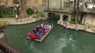 Debris falls into the River Walk on Wednesday