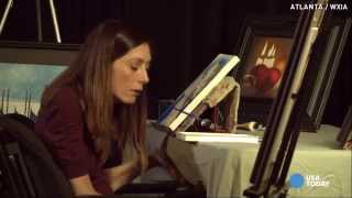 Paralyzed painter uses teeth to create masterpieces