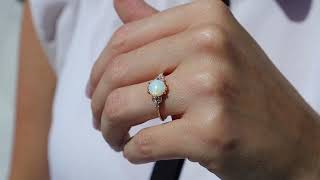 Gold engagement ring with a 7 mm opal in the center