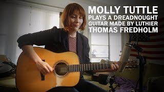 Molly Tuttle plays a Fredholm dreadnought guitar