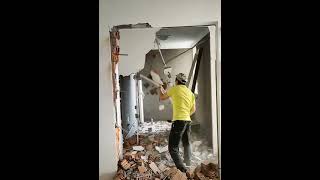 Construction worker destroy old house with hammer