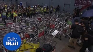 Hong Kong protesters set up a barricade at airport bus station